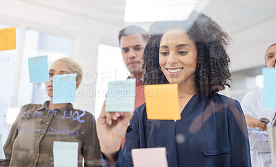 Buy stock photo Black woman, smile and writing schedule in planning, strategy or brainstorming on glass wall at office. African American female designer in teamwork project plan, tasks or post it with sticky note