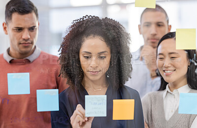 Buy stock photo Black woman, writing and schedule planning for strategy or team brainstorming on glass wall at office. African American female designer in teamwork project plan, tasks or post it with sticky note