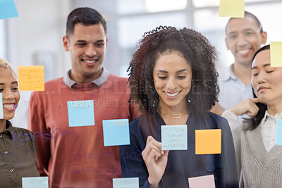 Buy stock photo Black woman, writing and schedule planning with team in strategy or brainstorming on glass wall at office. African American female designer in teamwork project plan, tasks or post it with sticky note