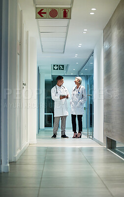 Buy stock photo Doctor, hospital corridor and healthcare workers in a medic conversation at clinic. Work communication, doctors and wellness employees talking on surgery break with collaboration and teamwork