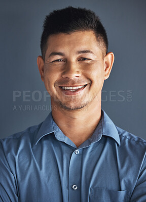 Buy stock photo Face portrait, smile and business man in studio isolated on a blue background. Ceo, boss goals and happy, confident and proud male entrepreneur from Brazil with vision, mission and success mindset.