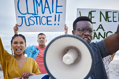 Buy stock photo Climate change sign, protest and black man with megaphone for freedom movement. Angry, crowd screaming and young people by the sea with world support for global, social and equality action at beach