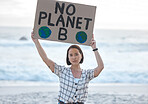Protest, climate change and woman with a sign on the beach to stop pollution and global warming. Political, earth activism and portrait of a Asian female leader with a board by the ocean for a march.