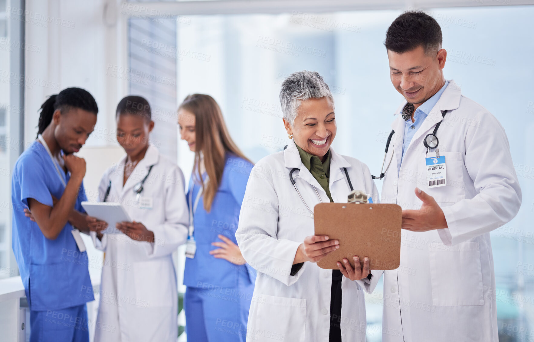 Buy stock photo Doctors team, man and woman with checklist, smile and happy for results, progress or feedback in clinic. Doctor, nurse and diversity with paperwork, tablet and happiness for team building in hospital