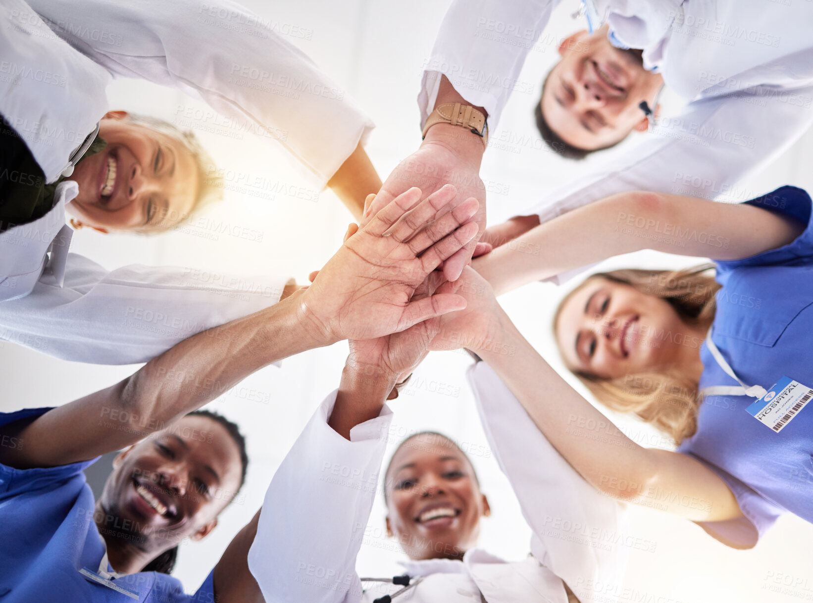 Buy stock photo Hands, healthcare and a team of doctors in a huddle in the hospital together from below. Medical, diversity and solidarity with a medicine professional group standing in a circle in a clinic