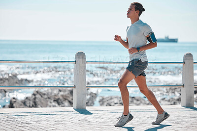 Buy stock photo Fitness, running and man by ocean for exercise, marathon training and endurance workout in action. Sports mockup, motivation and male runner focus for wellness, healthy body and performance in Miami
