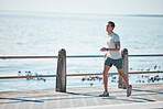 Sports, fitness and man running by ocean in action for wellness, performance and athlete endurance. Nature, motivation and male runner by sea for exercise mockup, marathon training and cardio workout