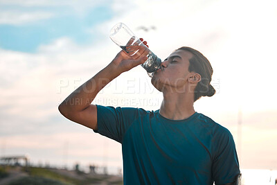 Buy stock photo Fitness, exercise and man drinking water for wellness, healthy lifestyle and hydration after workout. Sports mockup, sunset and male athlete with minerals for running, endurance training and cardio