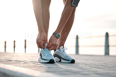 Buy stock photo Fitness, running and man tie shoes by ocean ready for exercise, marathon training and cardio workout. Start sports mockup, athlete and feet of male runner with shoelace for wellness and health