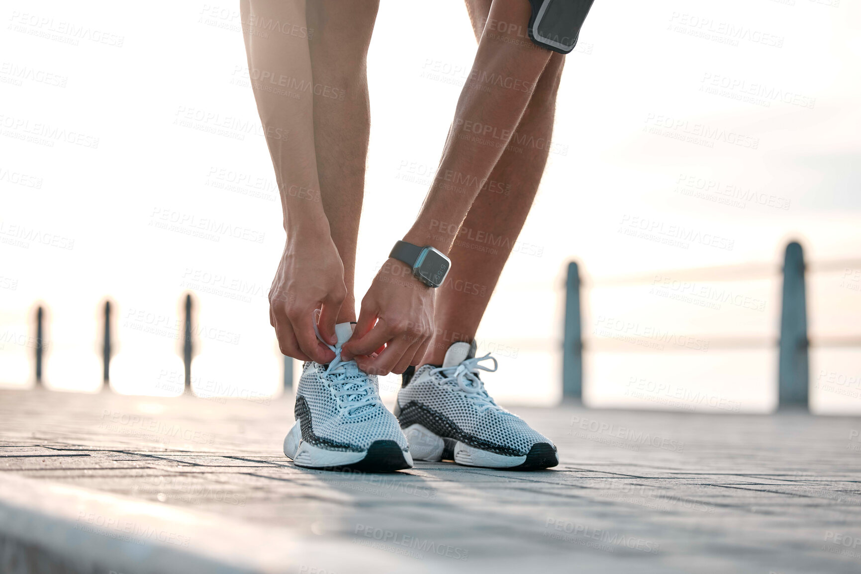 Buy stock photo Fitness, running and man tie shoes by ocean ready for exercise, marathon training and cardio workout. Start sports mockup, athlete and feet of male runner with shoelace for wellness and health