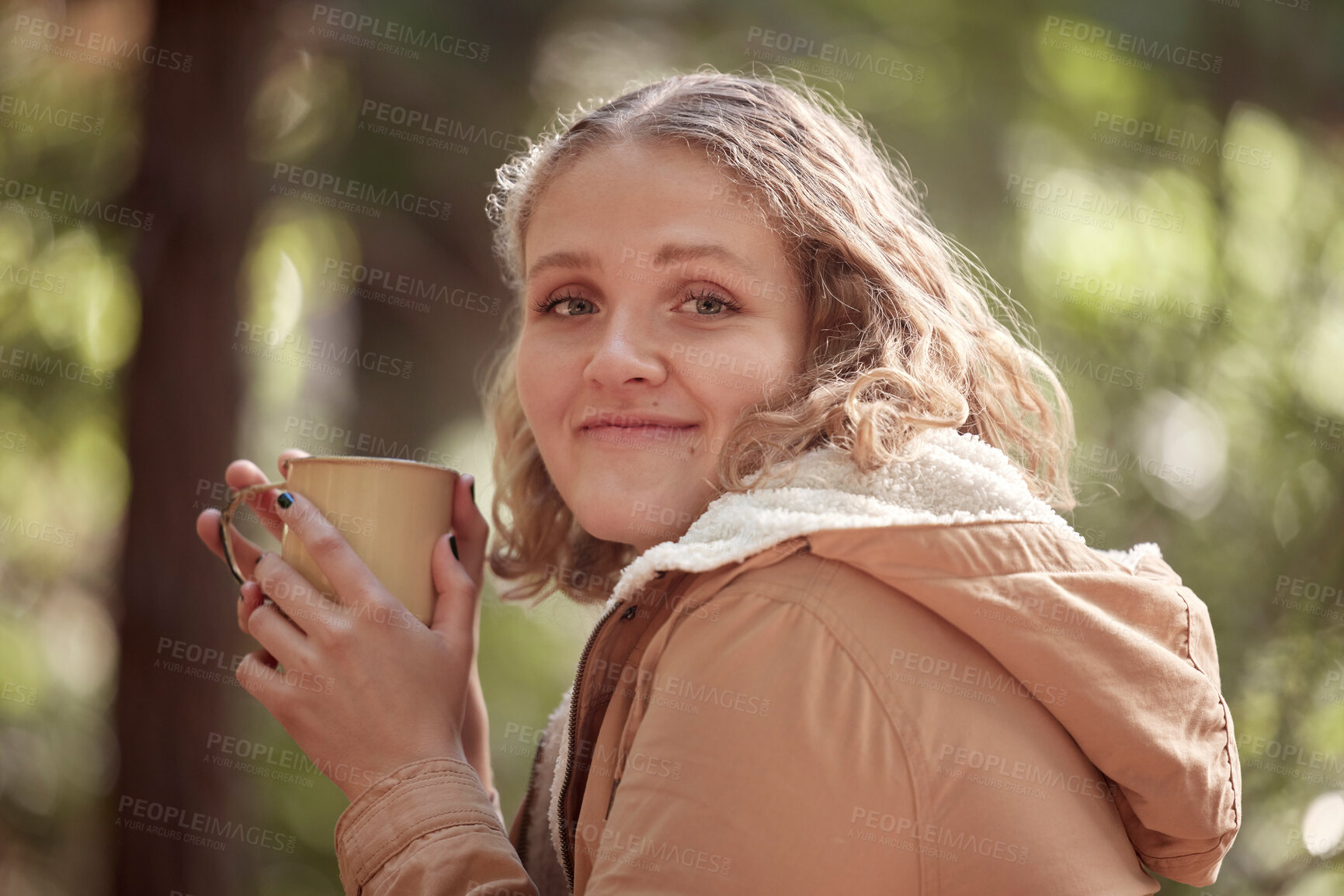 Buy stock photo Portrait, coffee and woman relax in forest, smile and happy in nature on bokeh background. Camping, face and tea break for girl in woods, peaceful and quiet while enjoying travel, vacation or trip