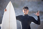 Surfer man, hand sign and portrait at beach, summer sports and freedom in sunshine. Surfing board, shaka and guy relax at ocean on adventure, sea travel and smile on holiday, vacation or fun in Miami