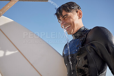 Buy stock photo Man, surfing and water shower at beach on face, smile or blue sky in summer, sunshine or ocean travel. Happy surfer cleaning body at tap for sea sports, relax holiday or vacation adventure in wetsuit