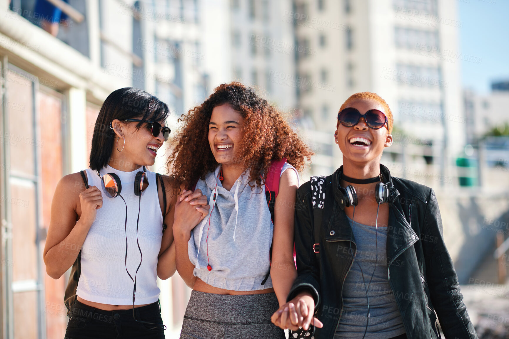 Buy stock photo Women friends, holding hands and walk in city with smile, support or happiness for summer travel together. Black woman students, laughing and comic joke with excited face, happy and group vacation