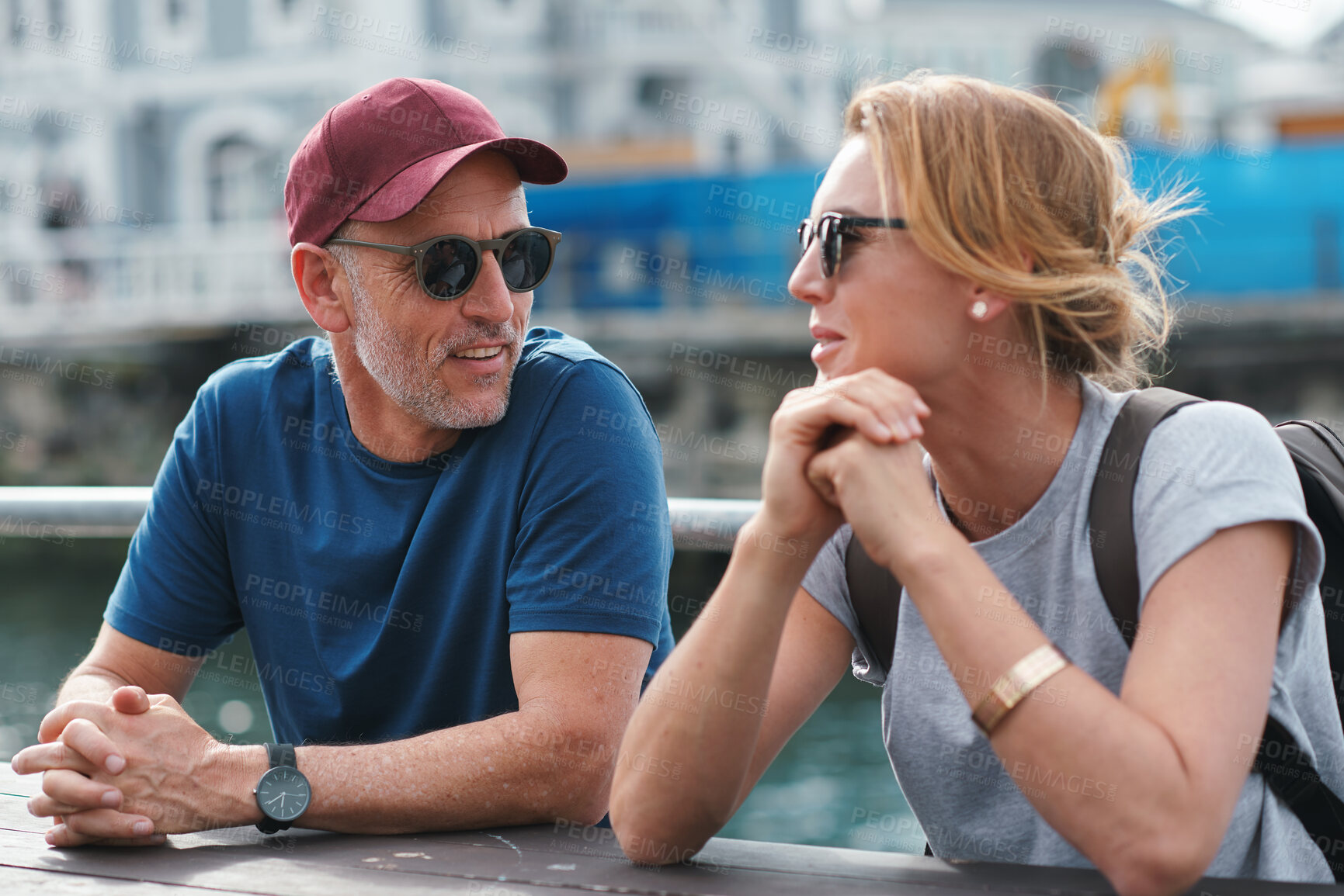 Buy stock photo Man, woman and travel with happy conversation at harbor, vacation or date by ocean in summer sunshine. Senior couple, talk and listening with care, romantic bonding or love by sea for outdoor holiday