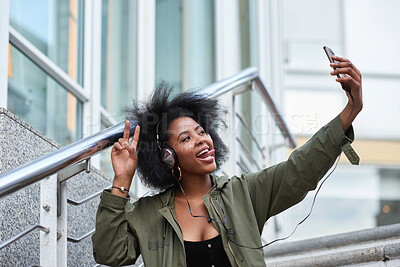 Buy stock photo Selfie, campus and black woman student taking picture to update social media in a city with a peace sign or hand gesture. Photo, internet and young female making funny face with tongue online in town
