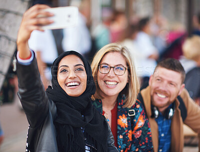 Buy stock photo Friends selfie, muslim woman and city with smile, man and happiness with smartphone on social media. Young gen z people, phone and profile picture for urban adventure in metro for outdoor photography
