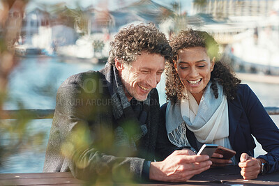 Buy stock photo Couple, phone and talking outdoor for travel, communication and 5g network connection on a bridge. Happy interracial man and woman together on vacation with a smartphone for location internet search 