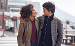Happy multiracial couple hug showing affection walking in city