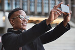 Younng african american man taking photo using smartphone in city photographing urban travel with mobile phone camera