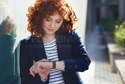 Buy stock photo Woman in city, checking time and smartwatch on wrist on morning commute to work or appointment. Street, schedule and businesswoman looking at watch on urban sidewalk before job interview or meeting.