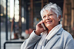 Senior business woman using smartphone talking on mobile phone in city having conversation 
