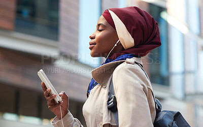 Buy stock photo Happy, music and phone with black woman in city for relax, streaming and social media. Independent, internet and hijab radio with muslim girl listening to earphones for podcast, online and digital