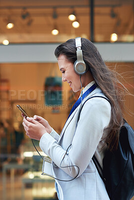 Buy stock photo Business woman, phone and smile listening to music in the city for communication, social media or chat. Female walking and typing on smartphone with 5G connection, mobile app and earphones in a town