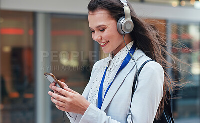 Buy stock photo Business, woman in city and smartphone with headphones, smile or walking in town, streaming music or radio. Female professional, consultant or agent outdoor, cellphone or headset for podcast or urban