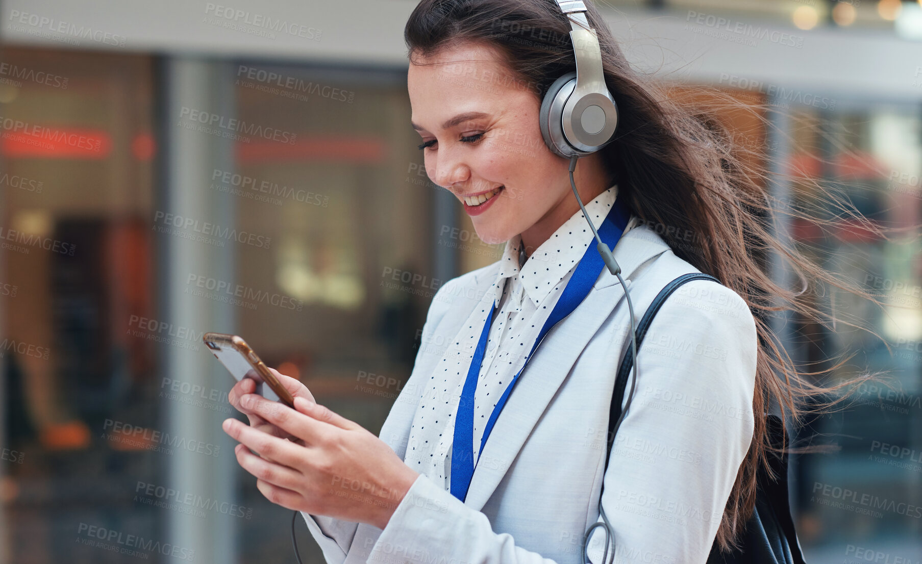 Buy stock photo Business, woman in city and smartphone with headphones, smile or walking in town, streaming music or radio. Female professional, consultant or agent outdoor, cellphone or headset for podcast or urban