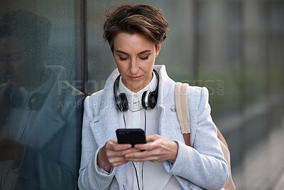 Buy stock photo Woman, phone and social media with communication outdoor, chat or email with headphones, travel to work and mockup space. Young creative in city, mobile app with technology and 5g network in Boston