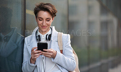 Buy stock photo Woman, smartphone and social media with communication in city, chat or email with headphones, travel to work and mockup space. Young creative outdoor, smile at online post with technology in Boston