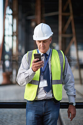 Buy stock photo Construction, engineer and man with a phone outdoor for building project management contact. Contractor person with helmet and smartphone for civil engineering, safety and development communication