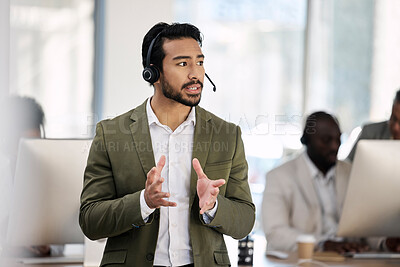 Buy stock photo Call center, serious and consulting with man in office for customer support, telemarketing and advisory. Help desk, team leader and contact us with employee listening for communication, sales and crm
