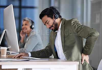 Buy stock photo Back pain, call center and tired man with stress, burnout and fatigue at crm or contact us help desk. Asian agent or consultant person in telemarketing, sales and customer service with pain or injury