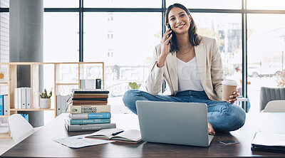 Buy stock photo Employee, laptop or phone call and sitting on desk in relax startup, marketing company or advertising business. Smile, happy or talking woman on mobile communication technology, laptop or books study