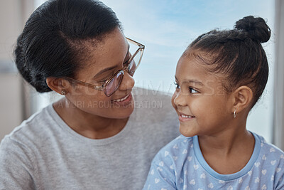 Buy stock photo Happy, smile and relax with mother and girl for bonding, quality time and affectionate. Happiness, care and support with mom and daughter at home for black family, smiling and  cute together
