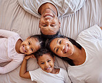 Portrait, family and children on a bed with their parents, lying together in the morning at home overhead. Love, relax or bedroom with a mother, father and kids bonding over the weekend in a circle