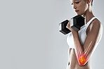 Fitness, weightlifting and dumbbell, arm injury and woman in pain, red overlay and x ray with skeleton on studio background. Mockup, bodybuilder and inflammation, medical emergency and muscle tension