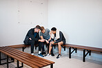 Sports, phone and friends in gym locker room after practice, exercise and training together. Wellness, fitness club and men on smartphone for social media, listening to music and relax from workout