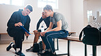 Sports, coach and men in locker room with strategy for game practice, exercise and training in gym. Coaching, sport club and male athletes planning, preparation and discussion with trainer for match