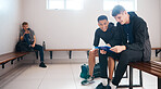 Sports, coach and men in gym locker room in strategy discussion for practice, exercise and training. Fitness health, club and male athletes with clipboard, planning and talking for workout routine