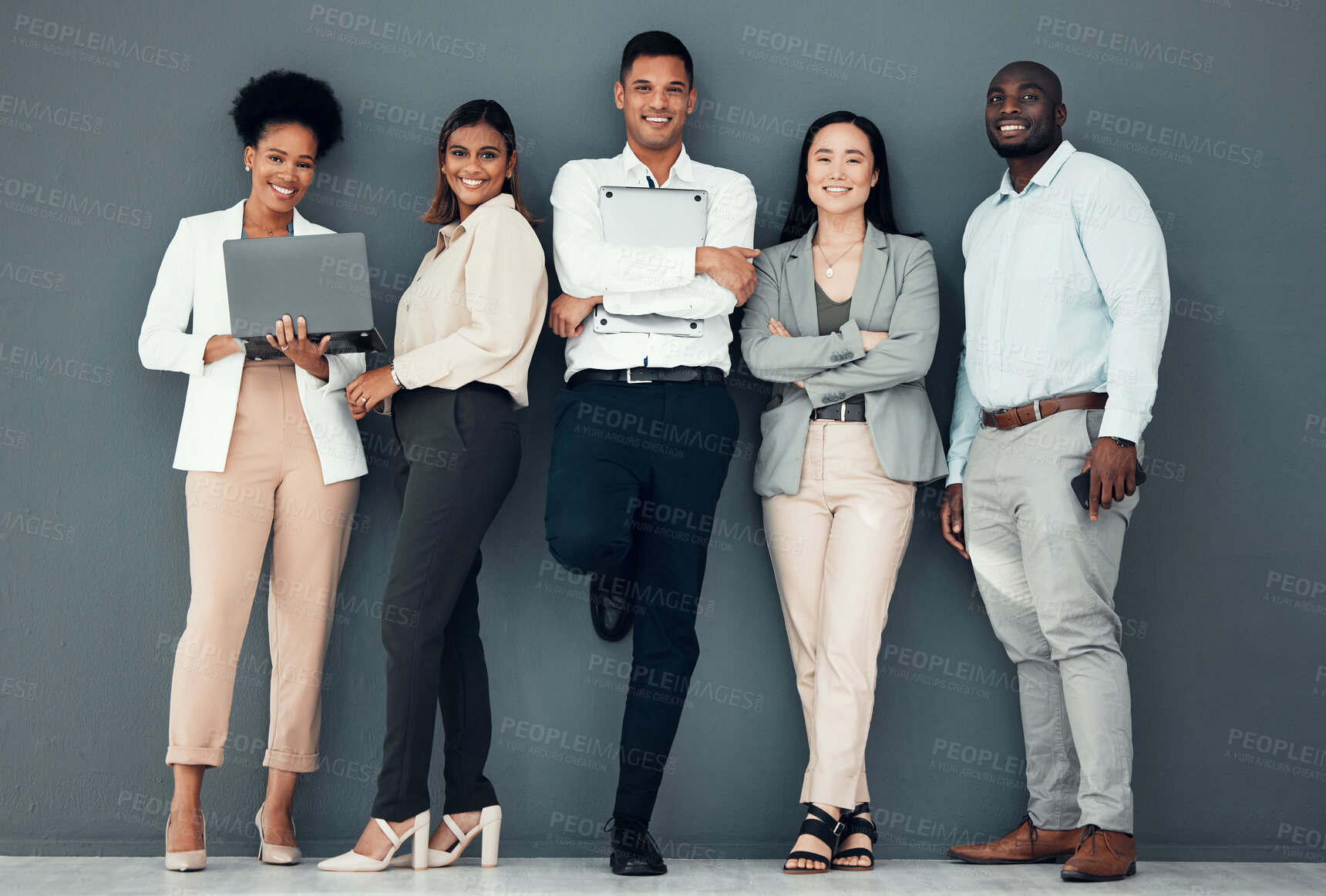Buy stock photo Business people, diversity and team, portrait with collaboration, happy and solidarity against wall background. Success, young professional group and working together with laptop, support and trust