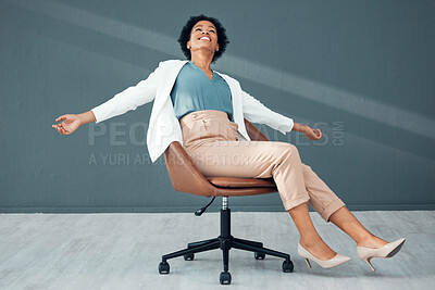 Buy stock photo Chair, fun and carefree with a business black woman sliding on the floor of her office feeling stress free. Freedom, relax and success with a female employee riding a seat alone in the workplace