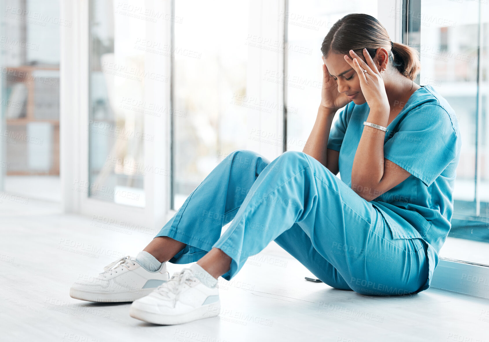 Buy stock photo Depression, headache and medical with nurse on floor of hospital for sad, mental health and burnout. Anxiety, stress and frustrated with tired woman in clinic for healthcare, medicine and nursing