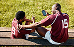 Rugby, teamwork and phone with sports man friends sitting on the bench during a game outdoor. Sport, fitness or social media with a male athlete and friend taking a break from training to rest