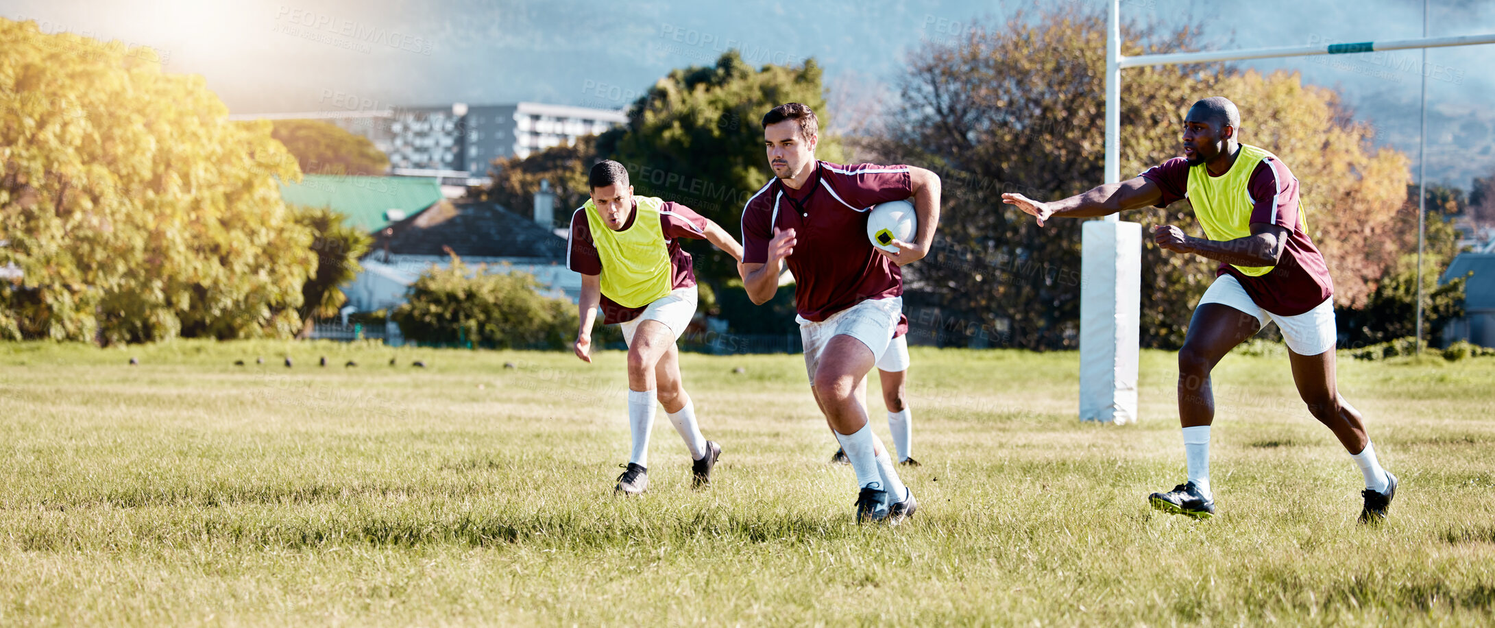 Buy stock photo Rugby, athlete on field and sport game with men, team and player with ball, fitness and active outdoor. Exercise, sports training and running, teamwork with competition and action with energy