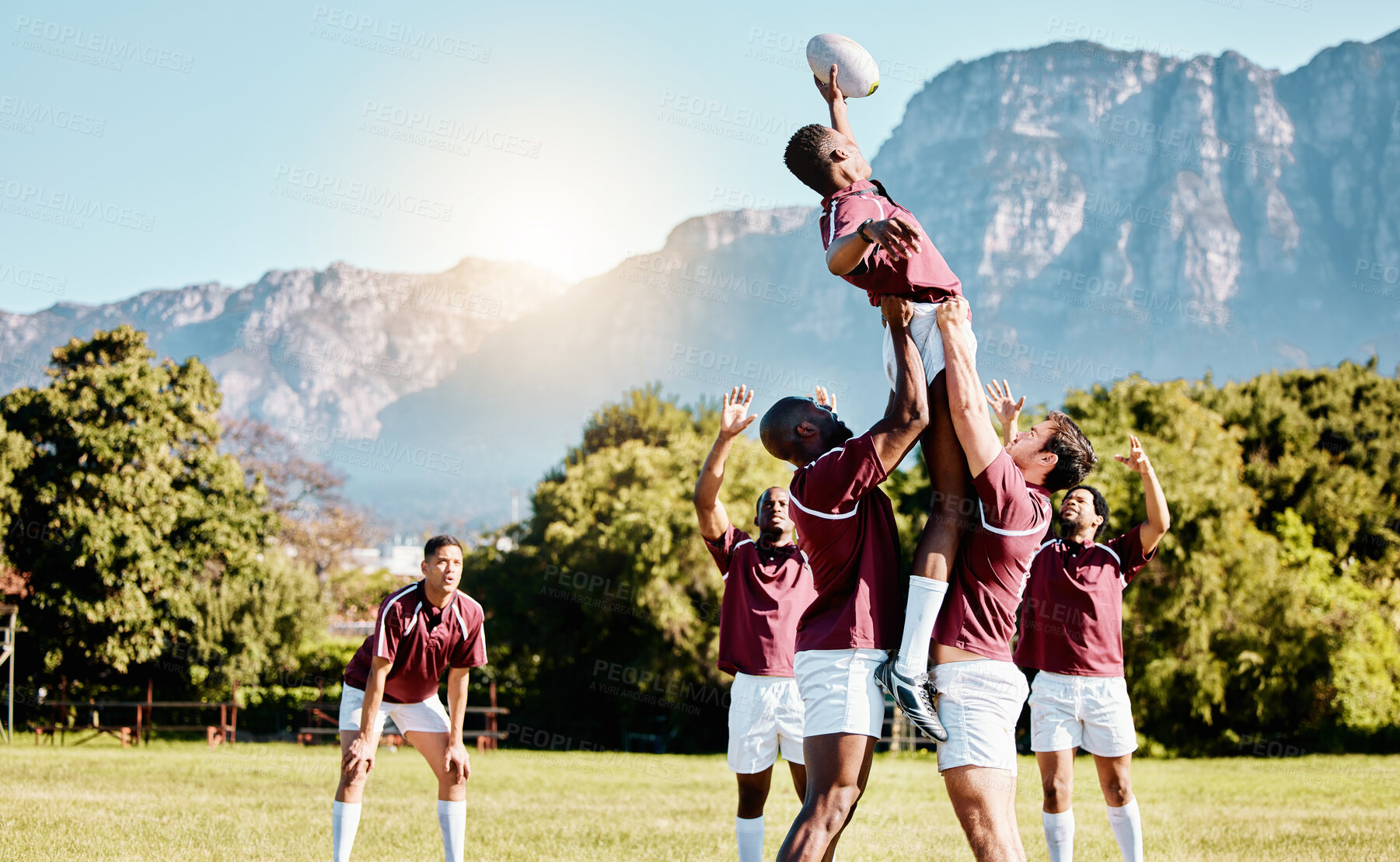 Buy stock photo Team, ball or rugby men lifting a man together in training, exercise or workout match on sports field. Jumping in air, line out or powerful group in competitive game with physical fitness or effort