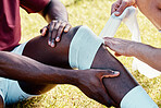 Rugby, knee injury and bandage with a sports black man on a field struggling with pain during a game. Fitness, medical and anatomy with a male athlete on a field suffering from an accident outdoor