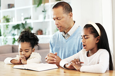 Buy stock photo Family, worship and bible with father and kids praying at table for peace, religion and faith in their home. God, pray and children with parent for prayer, bible study or Jesus Christ praise together